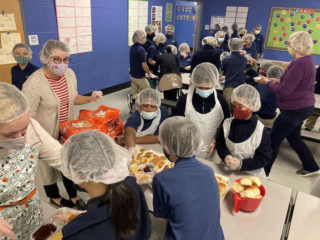 5th graders prepare Thanksgiving meals for those in need.